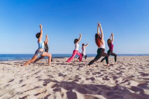 Girls doing yoga in Ibiza beach