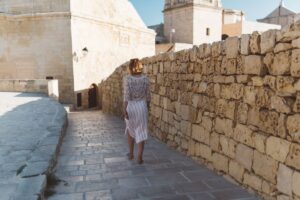 Solo traveler walking through the cobbled streets of Ibiza’s Old Town