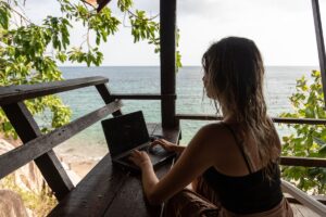 Digital nomad working remotely in a relaxed Ibiza café setting