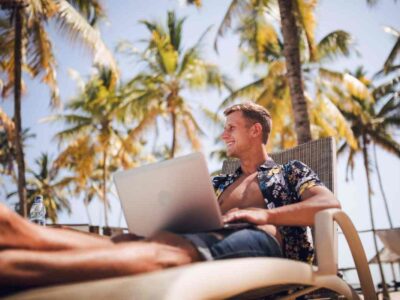 Digital nomad working remotely by the Ibiza coastline