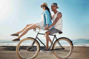 Couple enjoying a bike ride along the quiet coast of Formentera