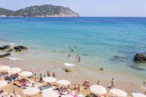 Golden sunrise over Aguas Blancas beach in Ibiza in August