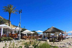 Luxury sunbeds and crowd at Blue Marlin beach club in Cala Jondal, Ibiza