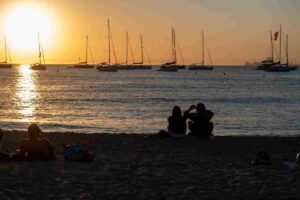 Sunset over Cala Saona beach with cliffs and calm sea in Formentera