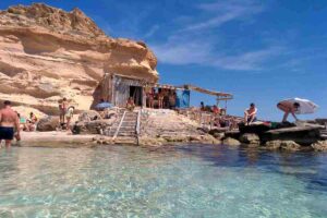 Snorkeler exploring crystal-clear waters at Es Caló des Mort in Formentera