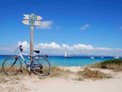 Tourist renting a bike to explore Formentera beaches near Ses Illetes