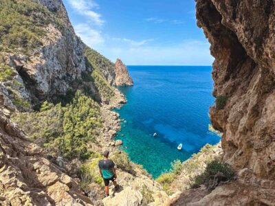 Small group of hikers walking through a rugged pine forest trail in the Es Amunts region of Ibiza during a guided morning tour