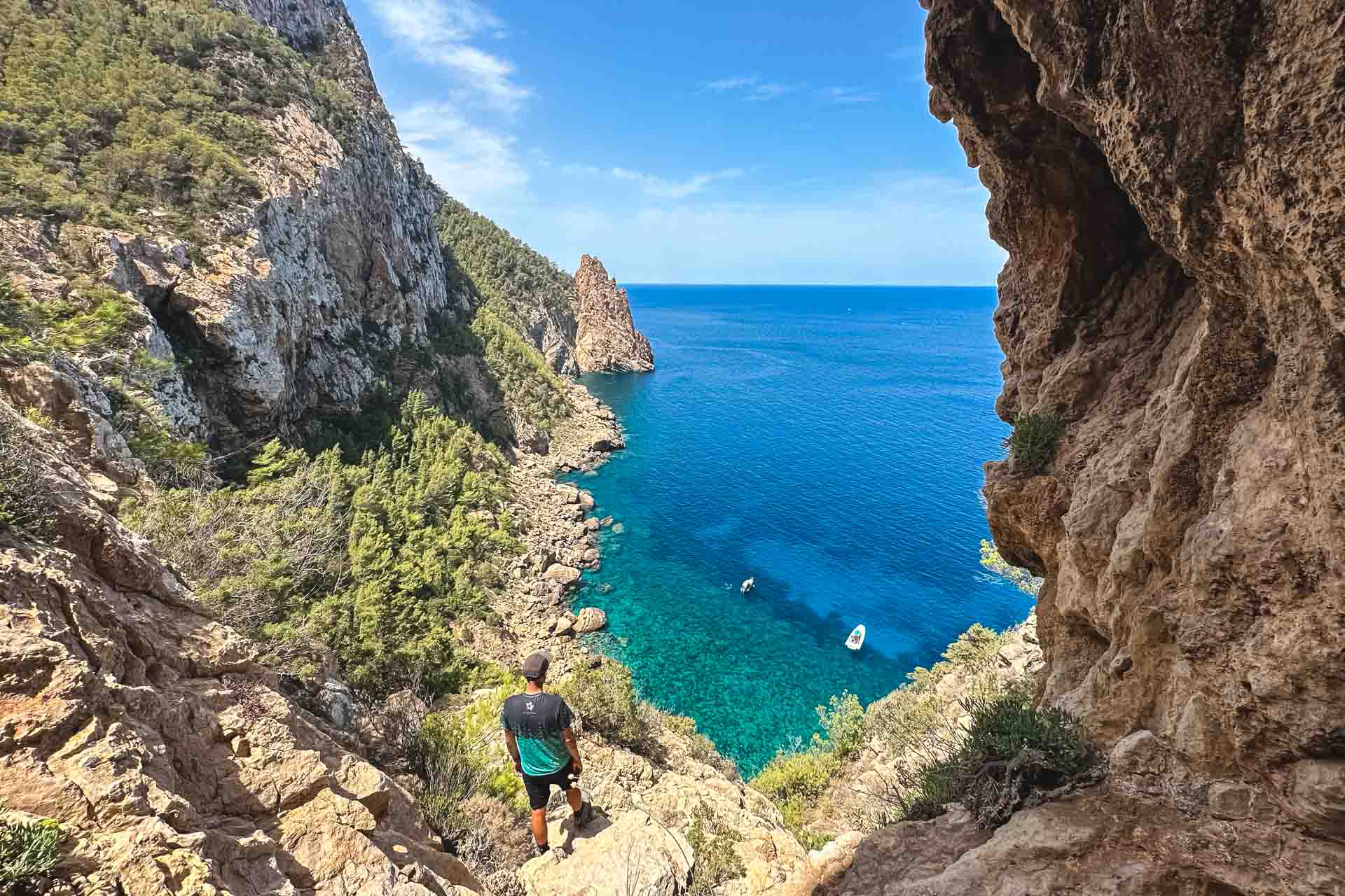 Small group of hikers walking through a rugged pine forest trail in the Es Amunts region of Ibiza during a guided morning tour