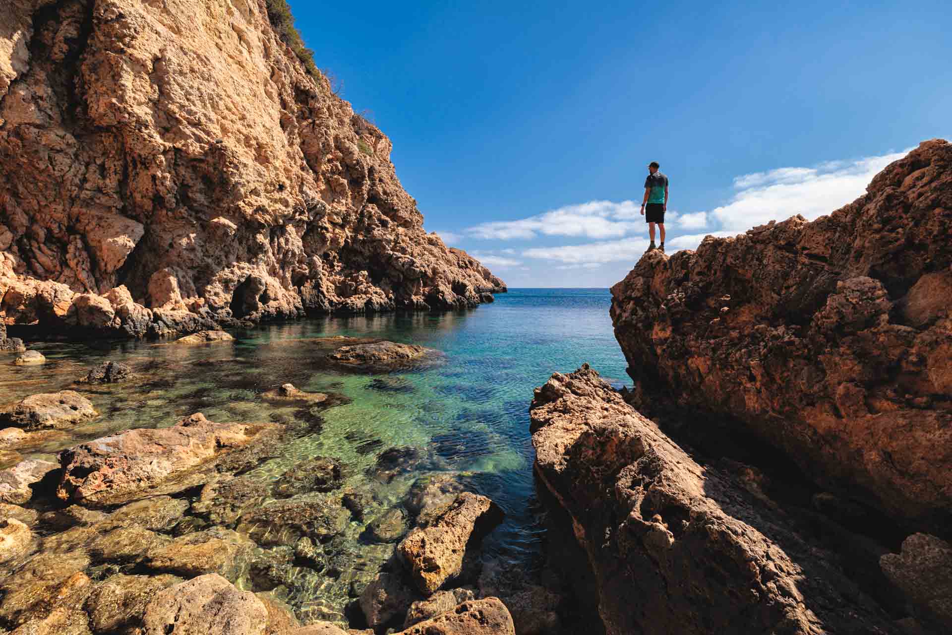 Turquoise waters in a hidden cove along Ibiza’s Crystal Coves trail