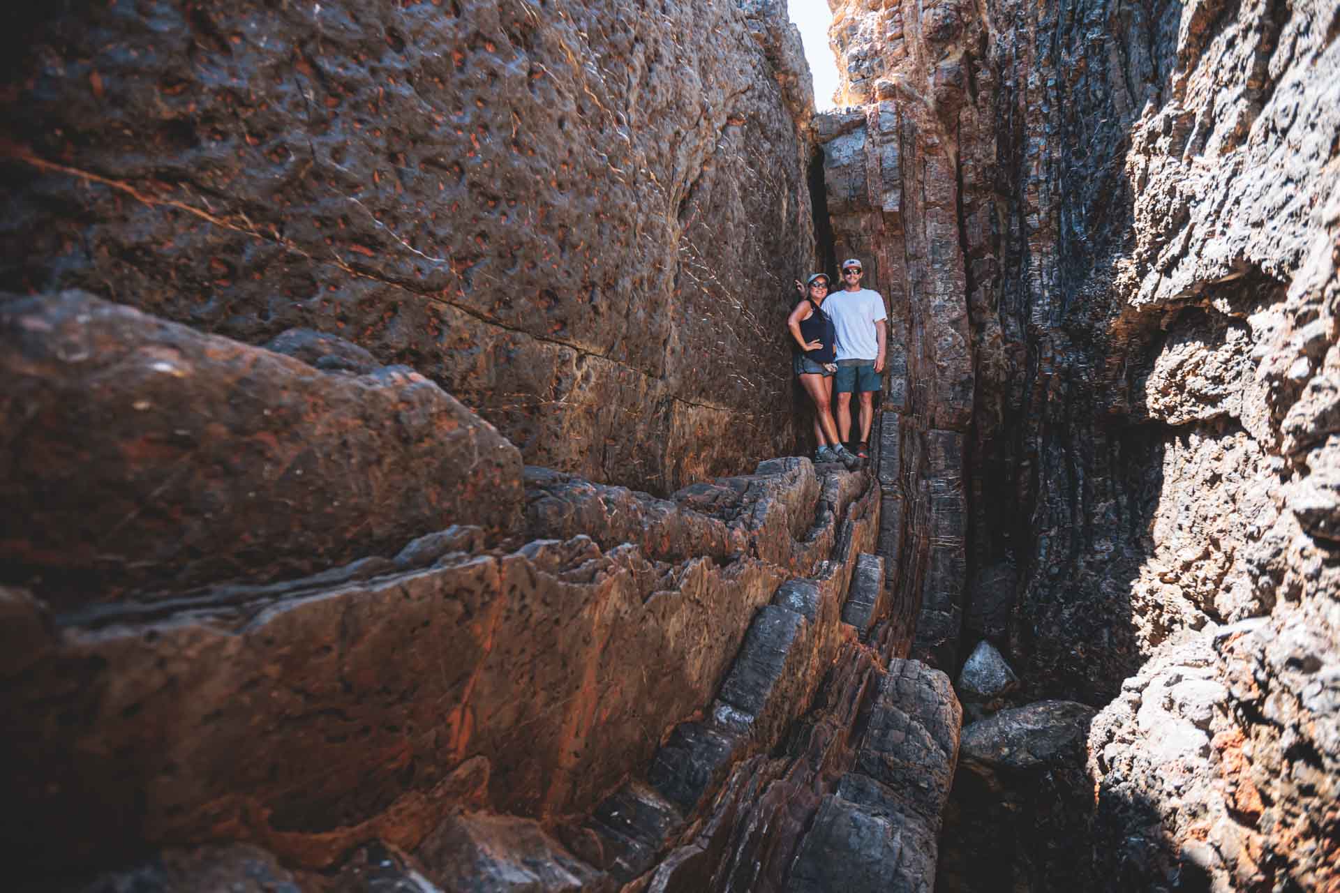 Hikers walking along ancient stone formations on Ibiza’s northeast coast