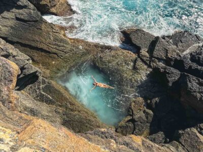 Natural pool formed in rock by erosion, where hikers stop to swim.