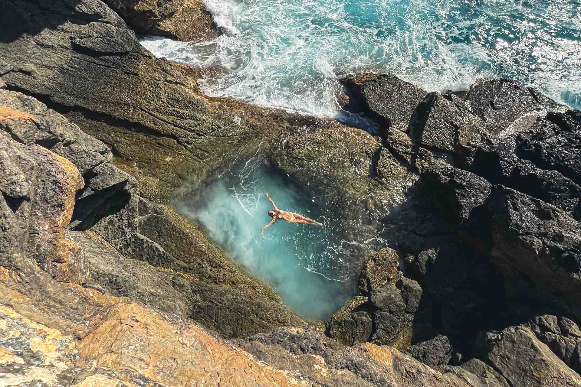 Natural pool formed in rock by erosion, where hikers stop to swim.