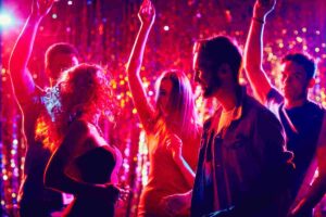Partygoers dancing in Hï Ibiza’s Wild Corner bathroom stage